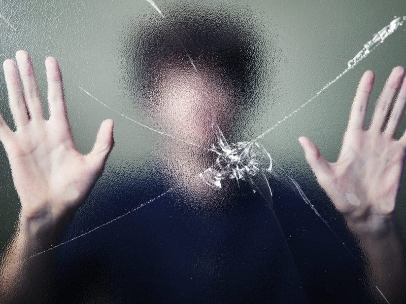 Anonymous man with cracked glass effect