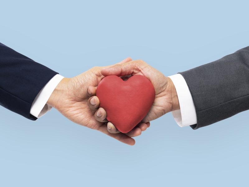 Hands holding heart in love and relationship concept